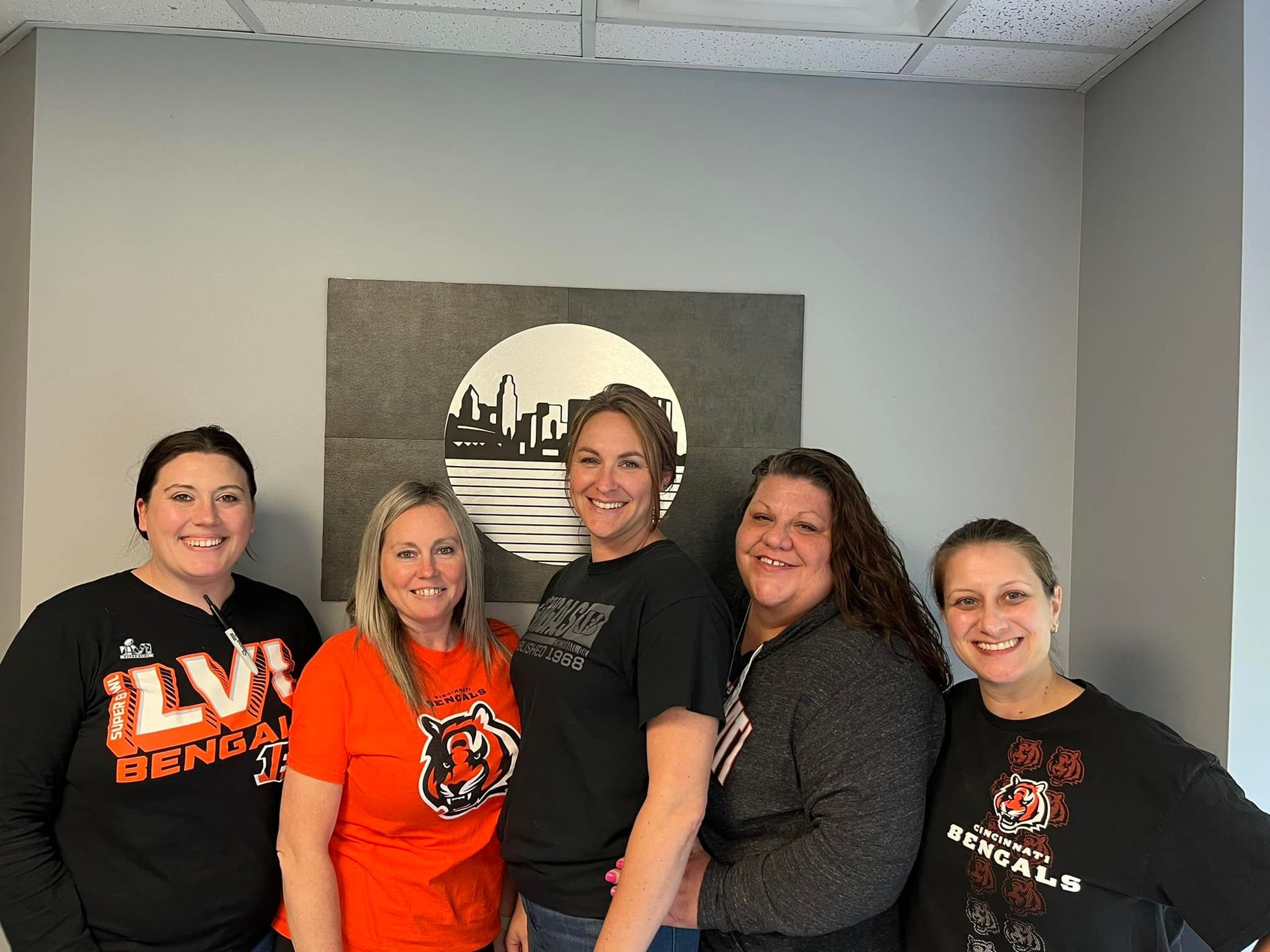 A group of women are posing for a picture in a room.