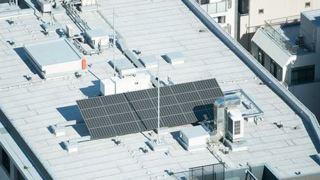 There are solar panels on the roof of a building.