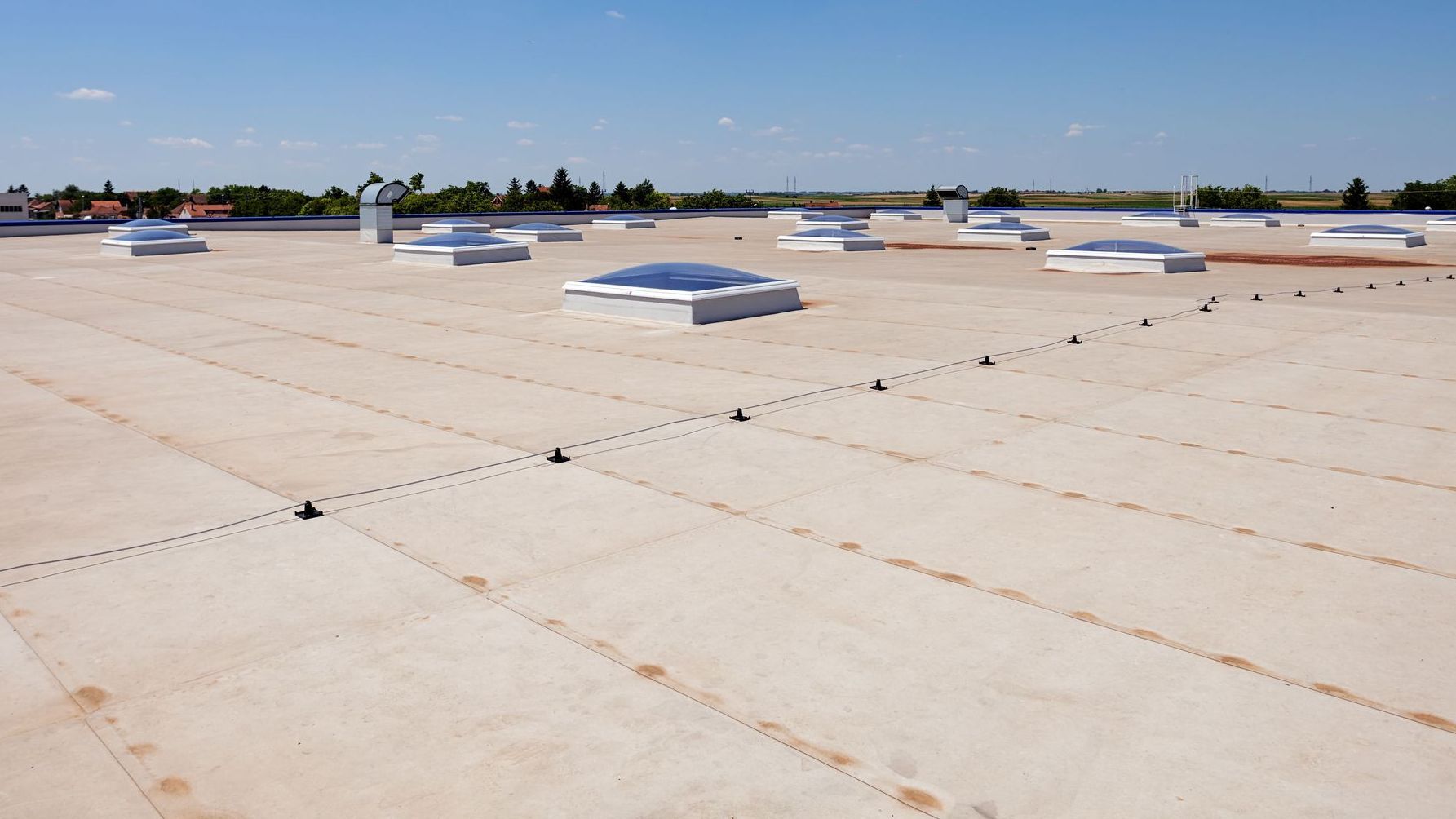 There are many skylights on the roof of a building.
