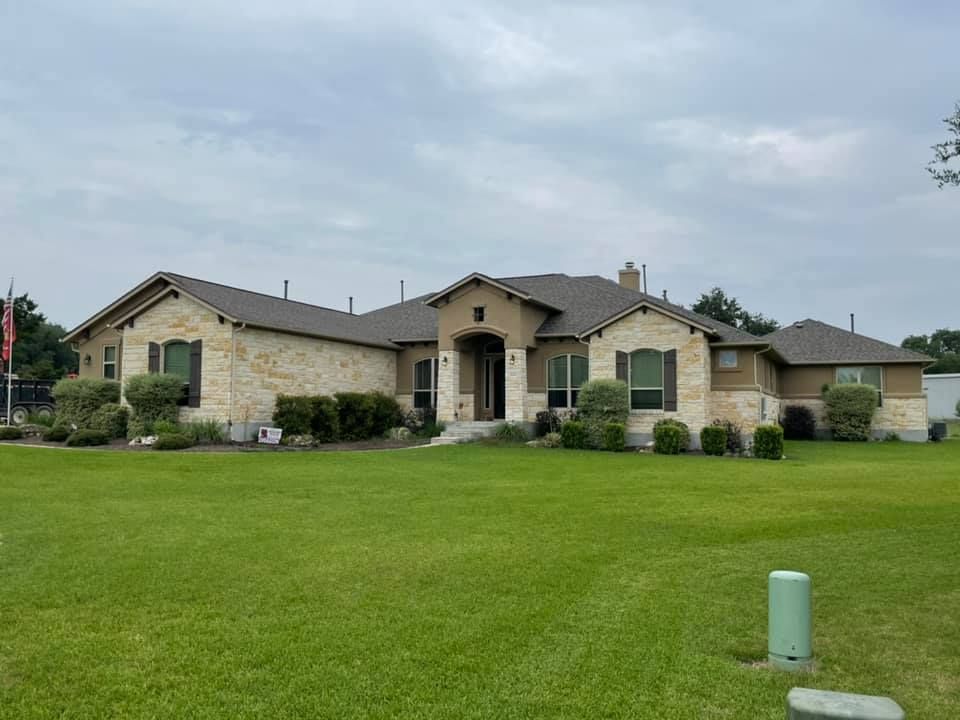 A large house with a large lawn in front of it