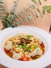 A close up of a bowl of food on a table.