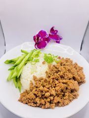 A white plate topped with rice , meat and green beans.
