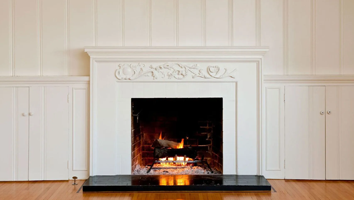 There is a fireplace in the middle of the room.