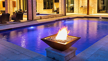 There is a fire pit in the middle of a swimming pool.