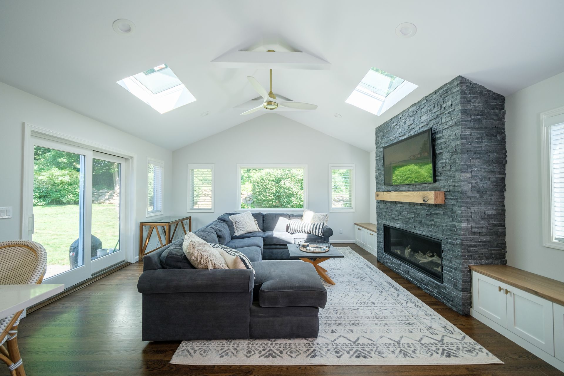 A living room with a couch , fireplace and television.