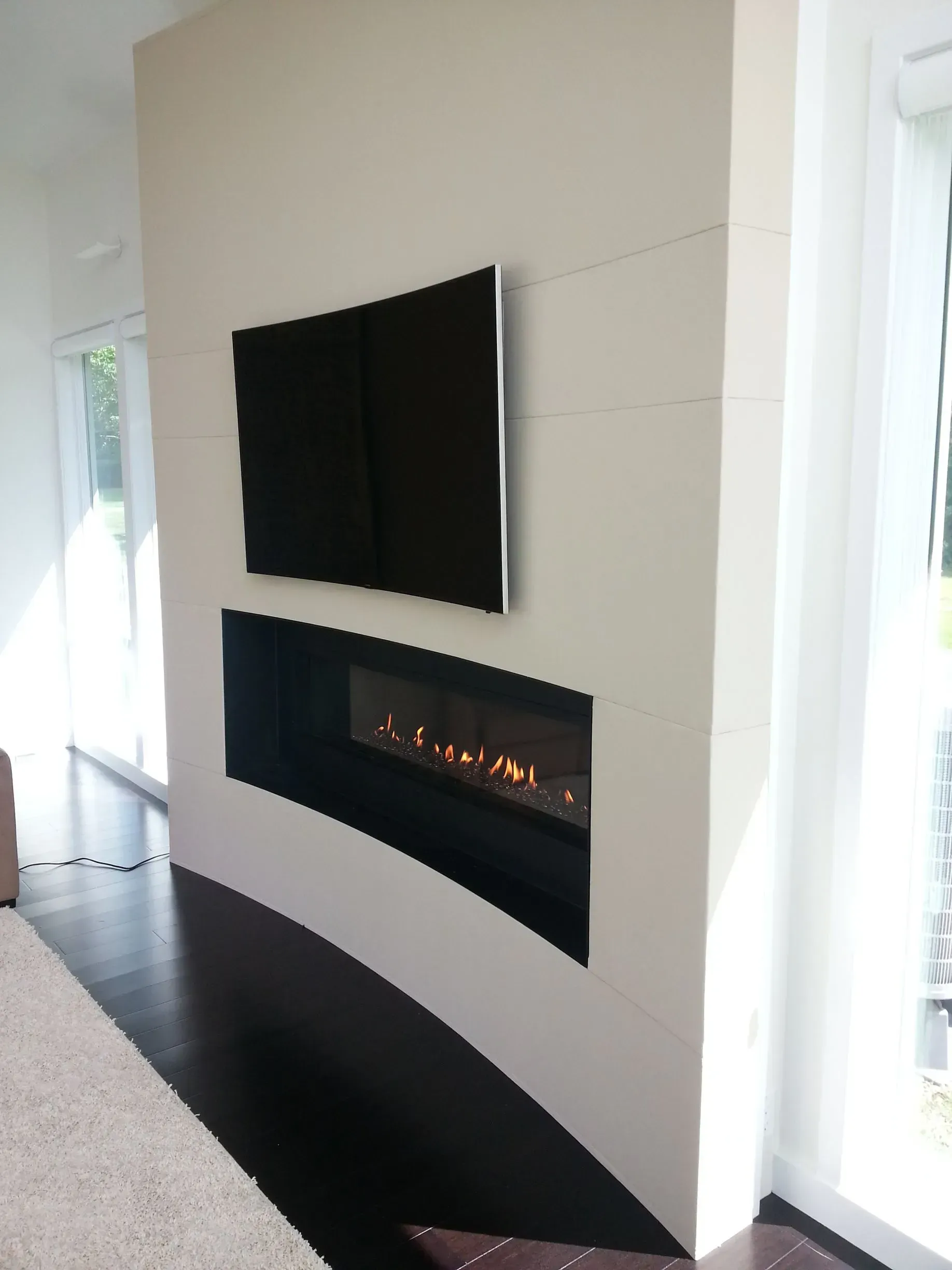 A living room with a fireplace and a flat screen tv
