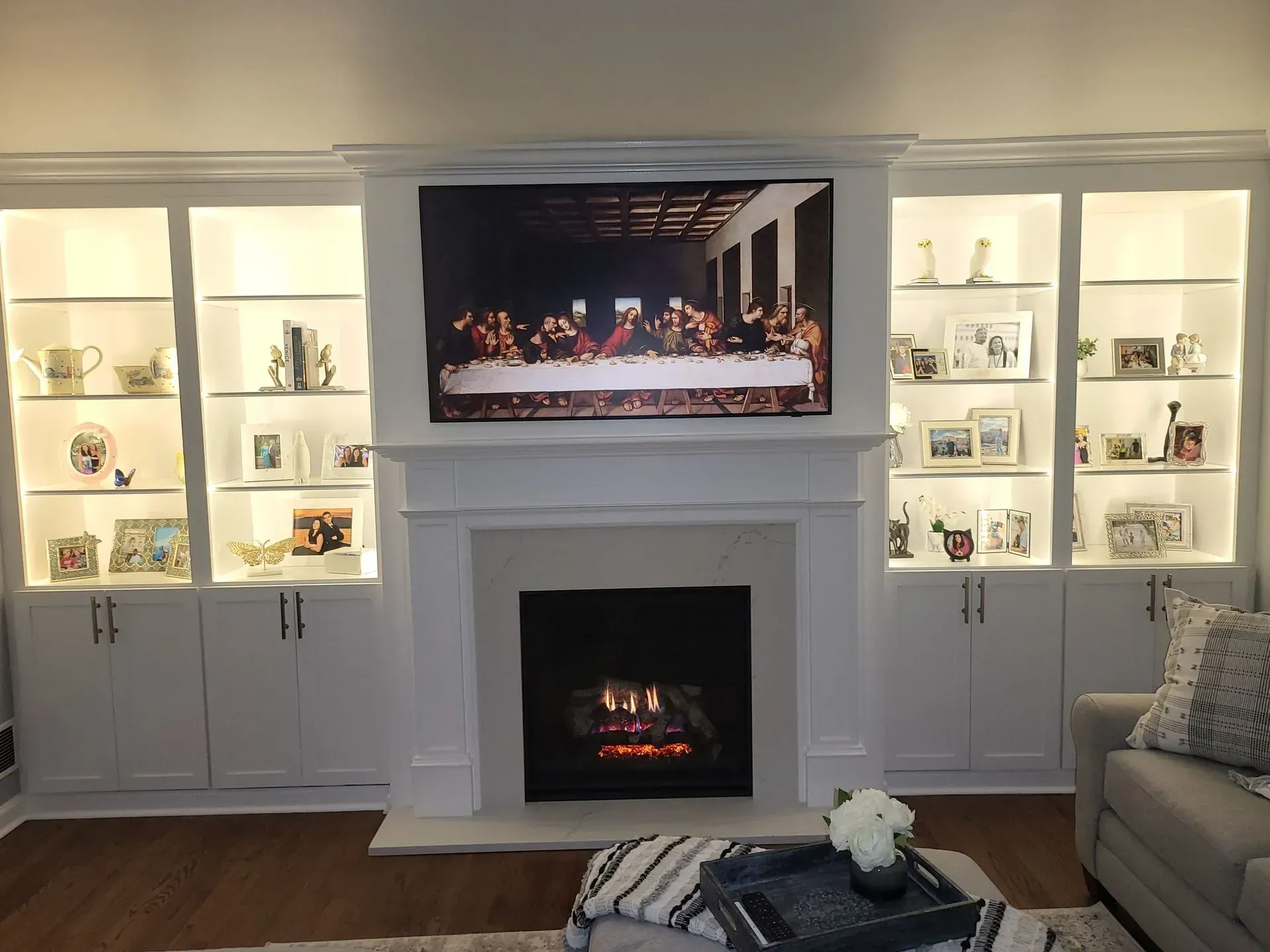 A living room with a fireplace and a flat screen tv