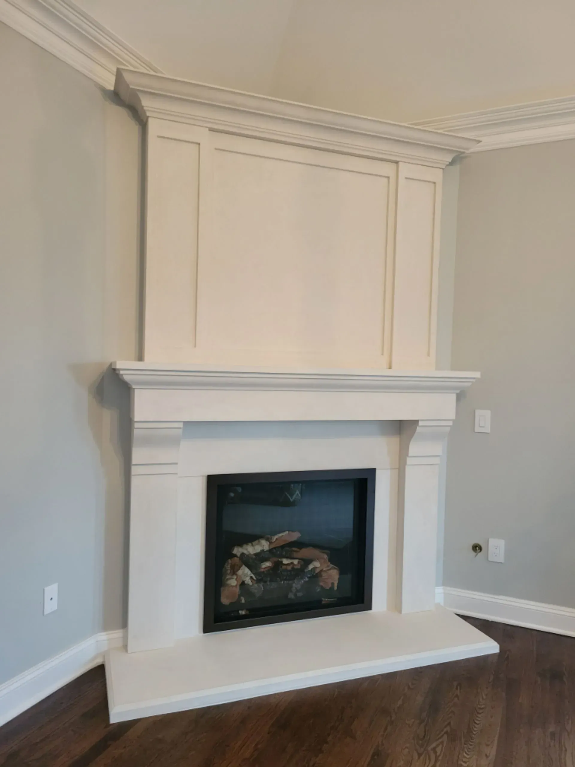 A living room with a fireplace and a wooden floor