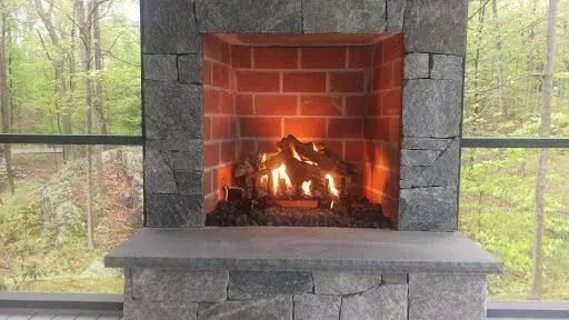 There is a fireplace with a lot of fire in it.