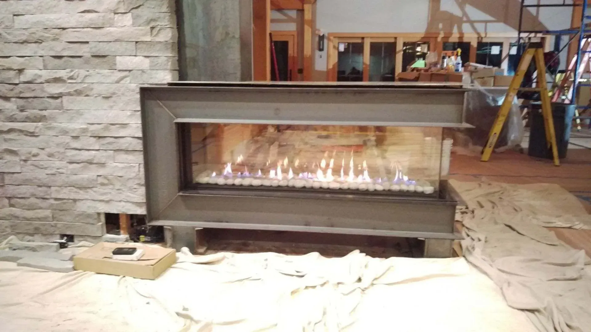 A fireplace is being installed in a living room.