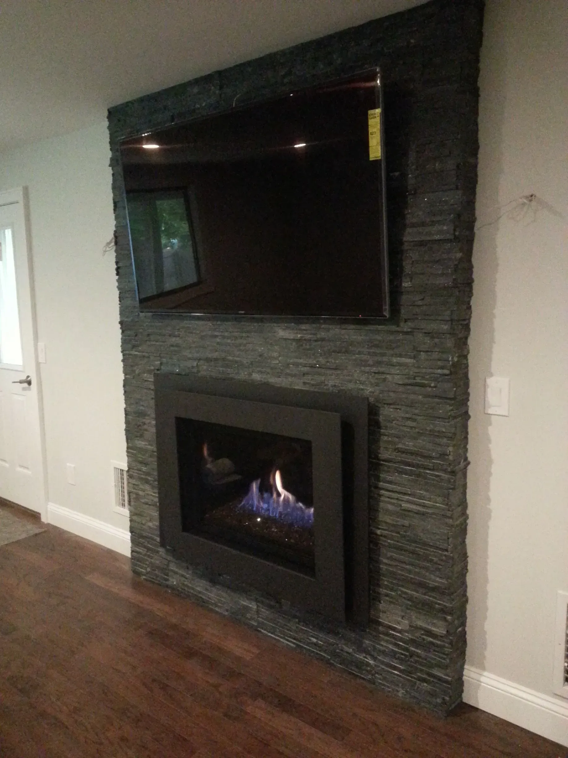 A fireplace with a flat screen tv above it in a living room.