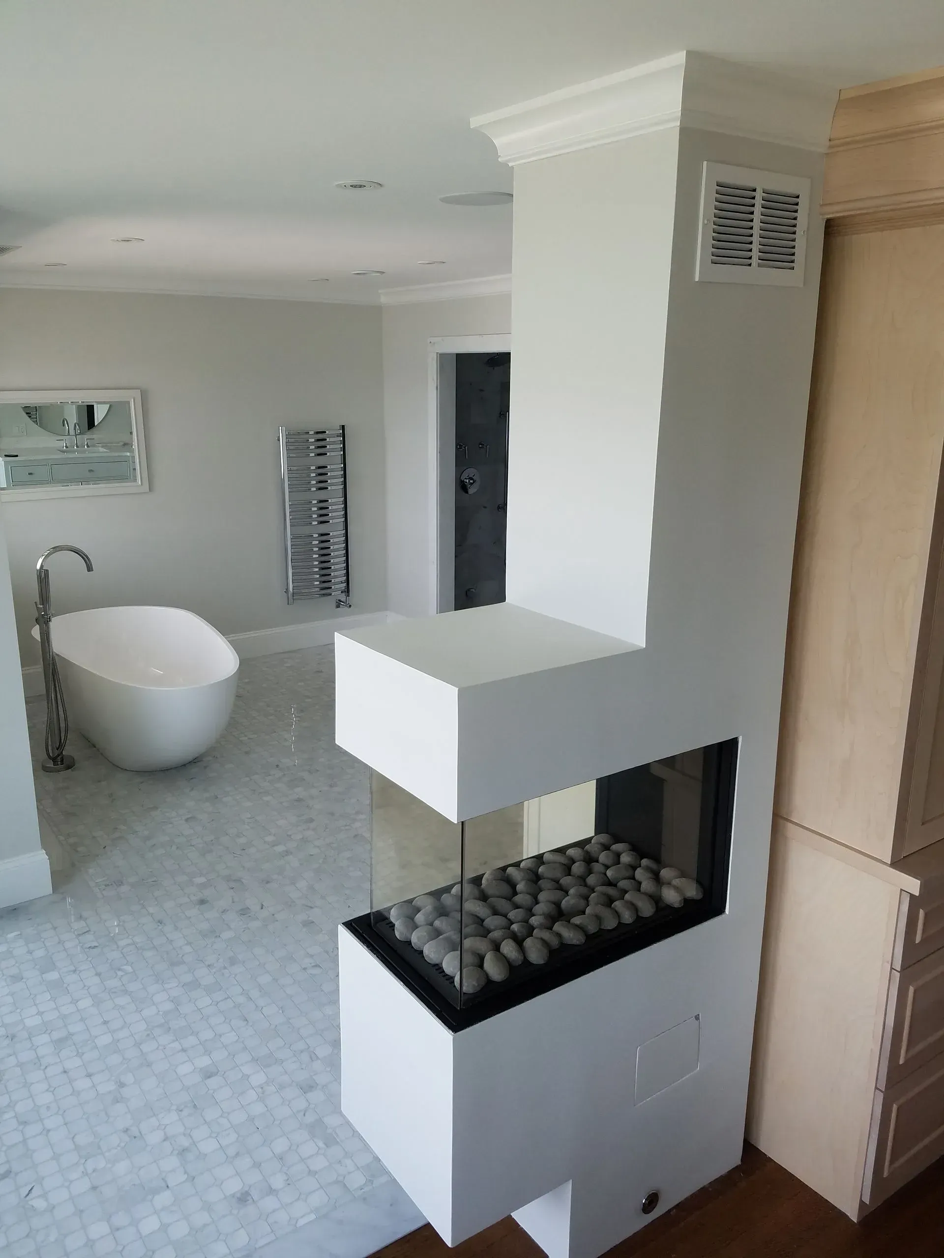 A bathroom with a bathtub and a fireplace