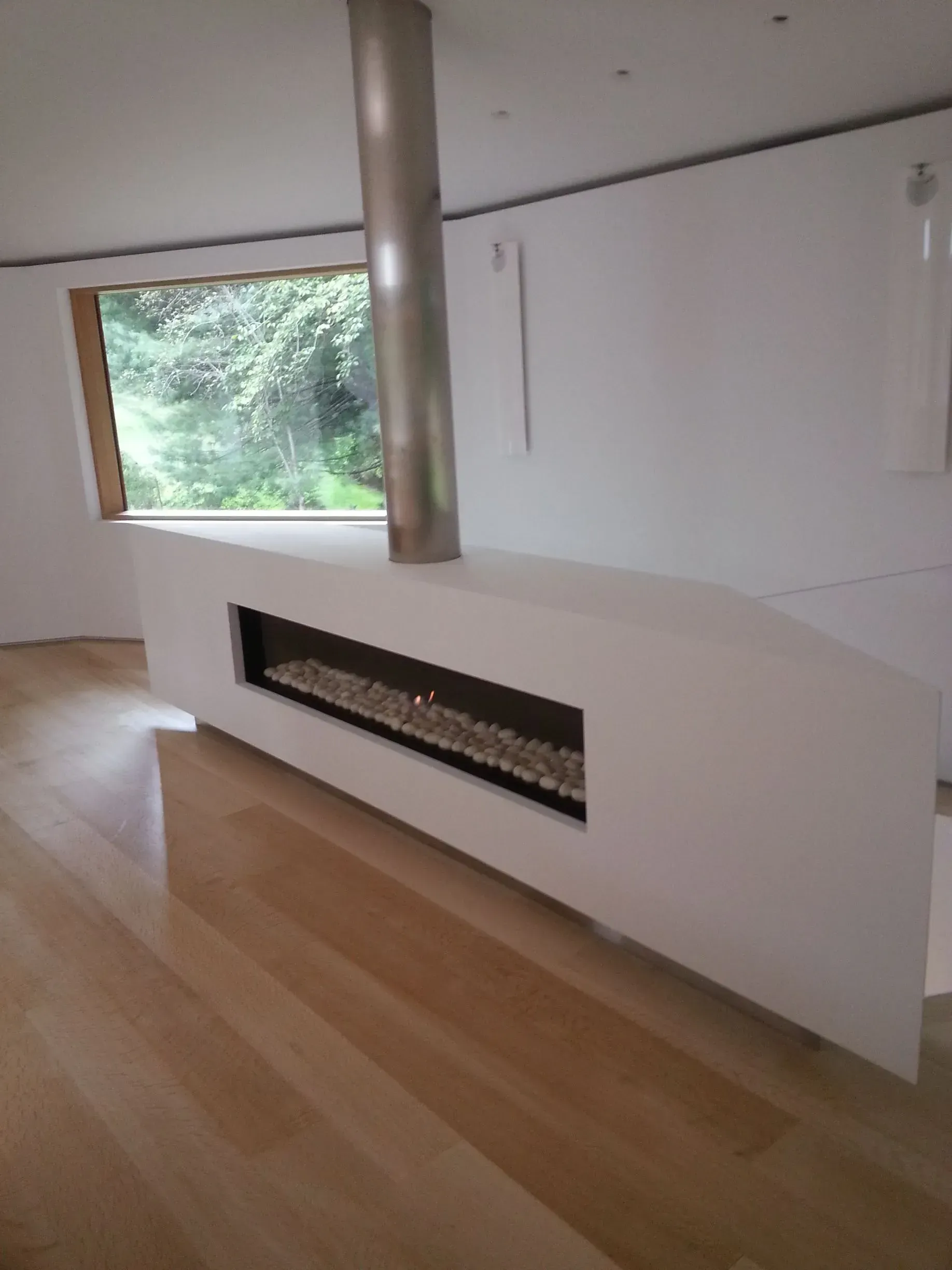 A living room with a fireplace and a window.