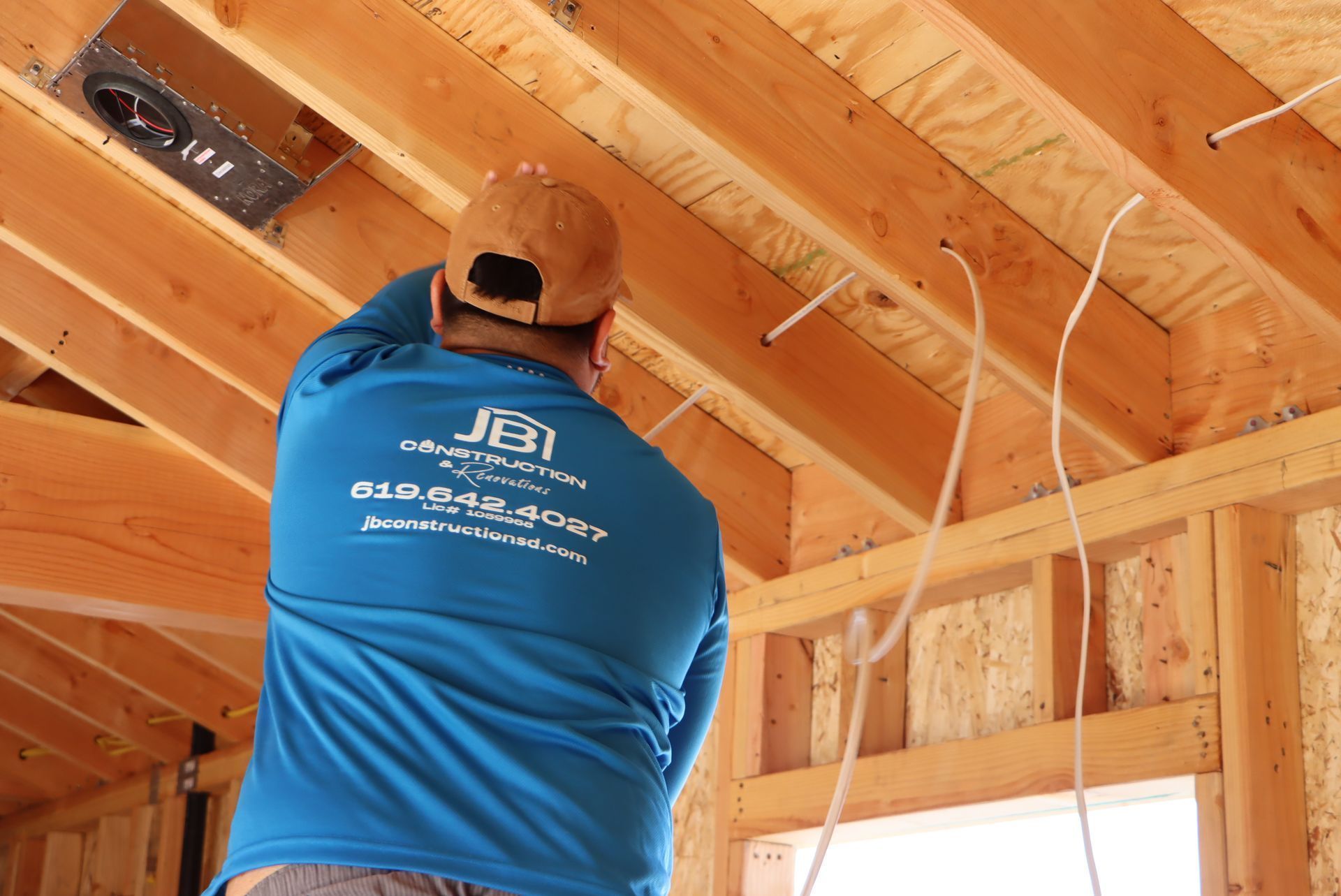 Modern kitchen with white cabinets, stainless steel appliances, large island with seating, and dark wood floors.