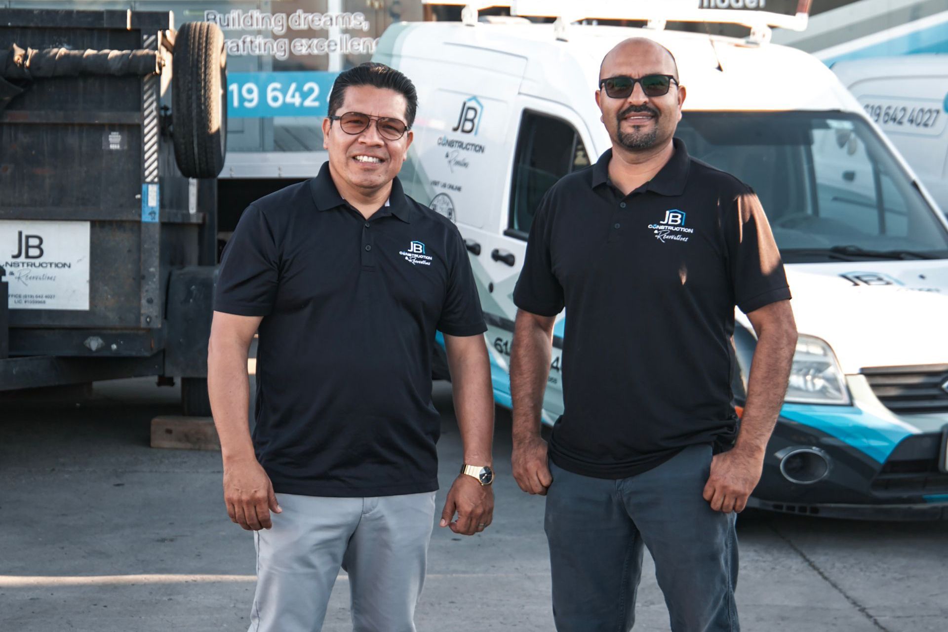 Two men standing in front of a van
