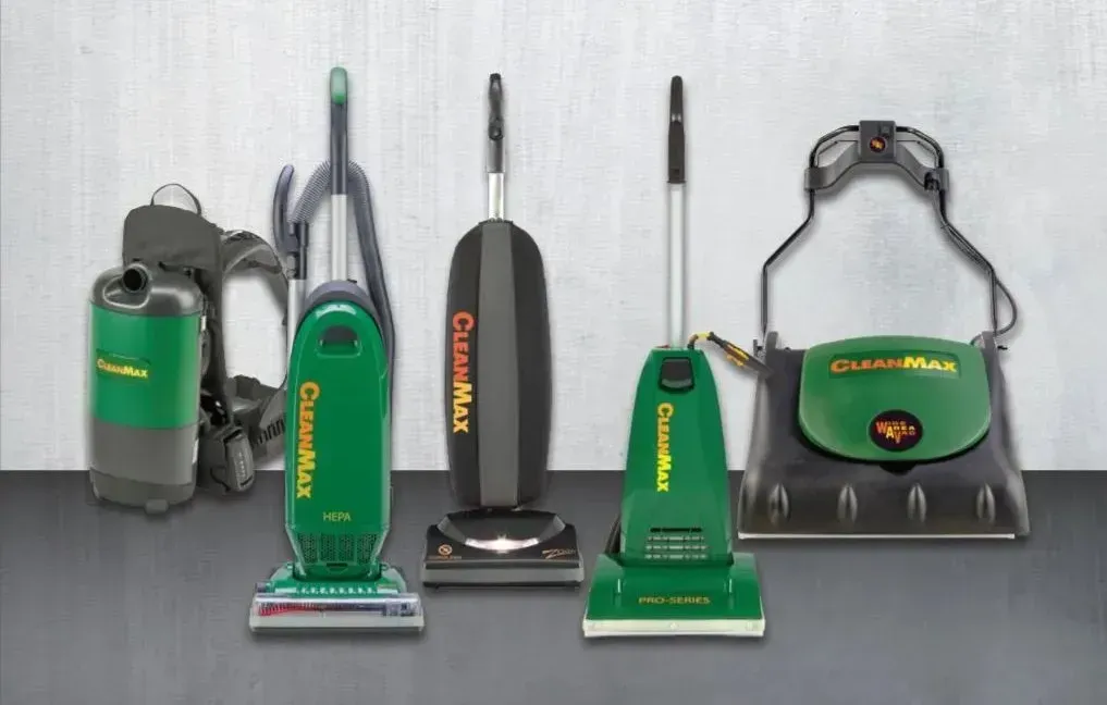 Five green and black CleanMax vacuum cleaners in various styles arranged in a row against a light grey background.