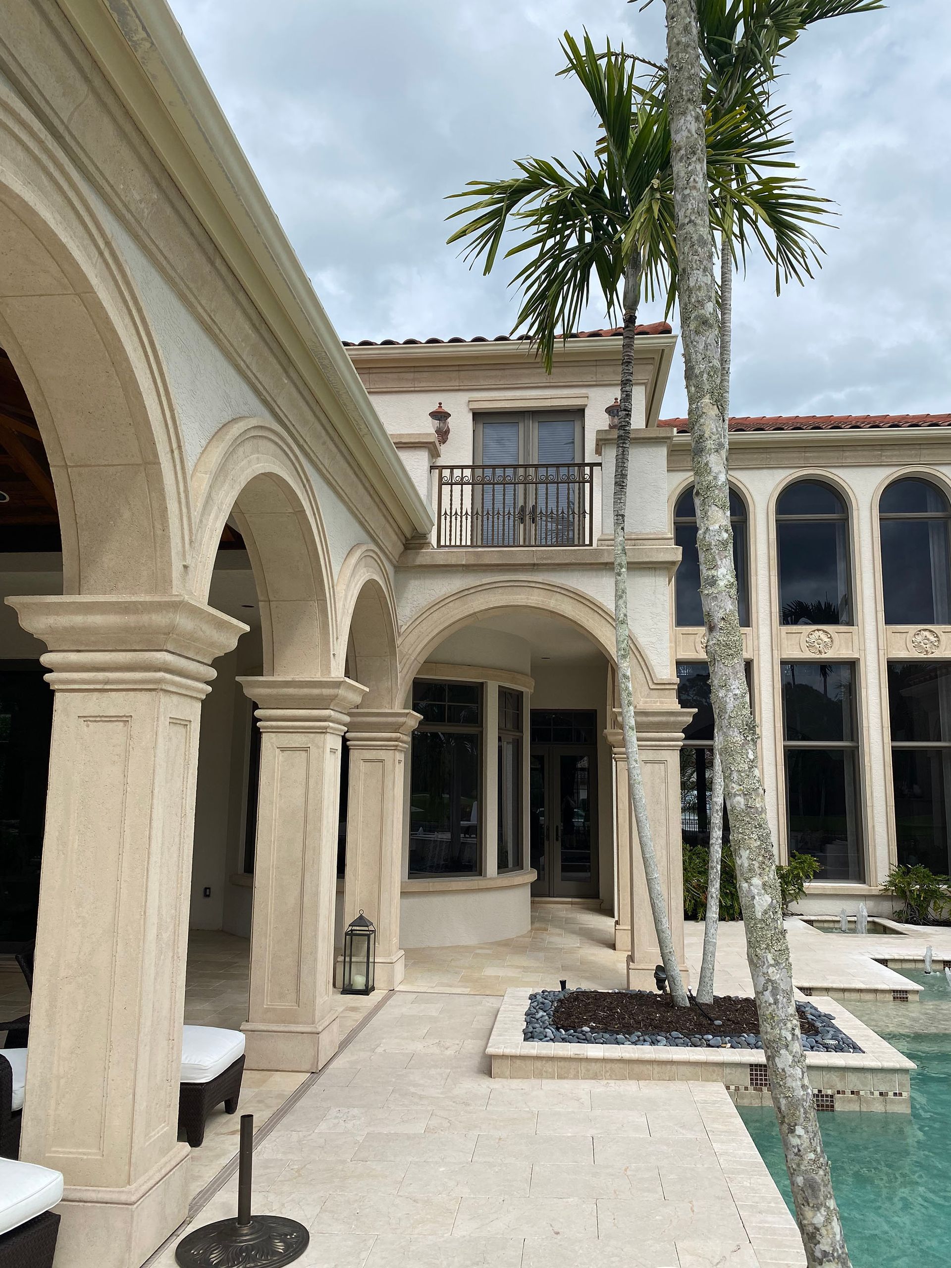 A large house with a palm tree in front of it