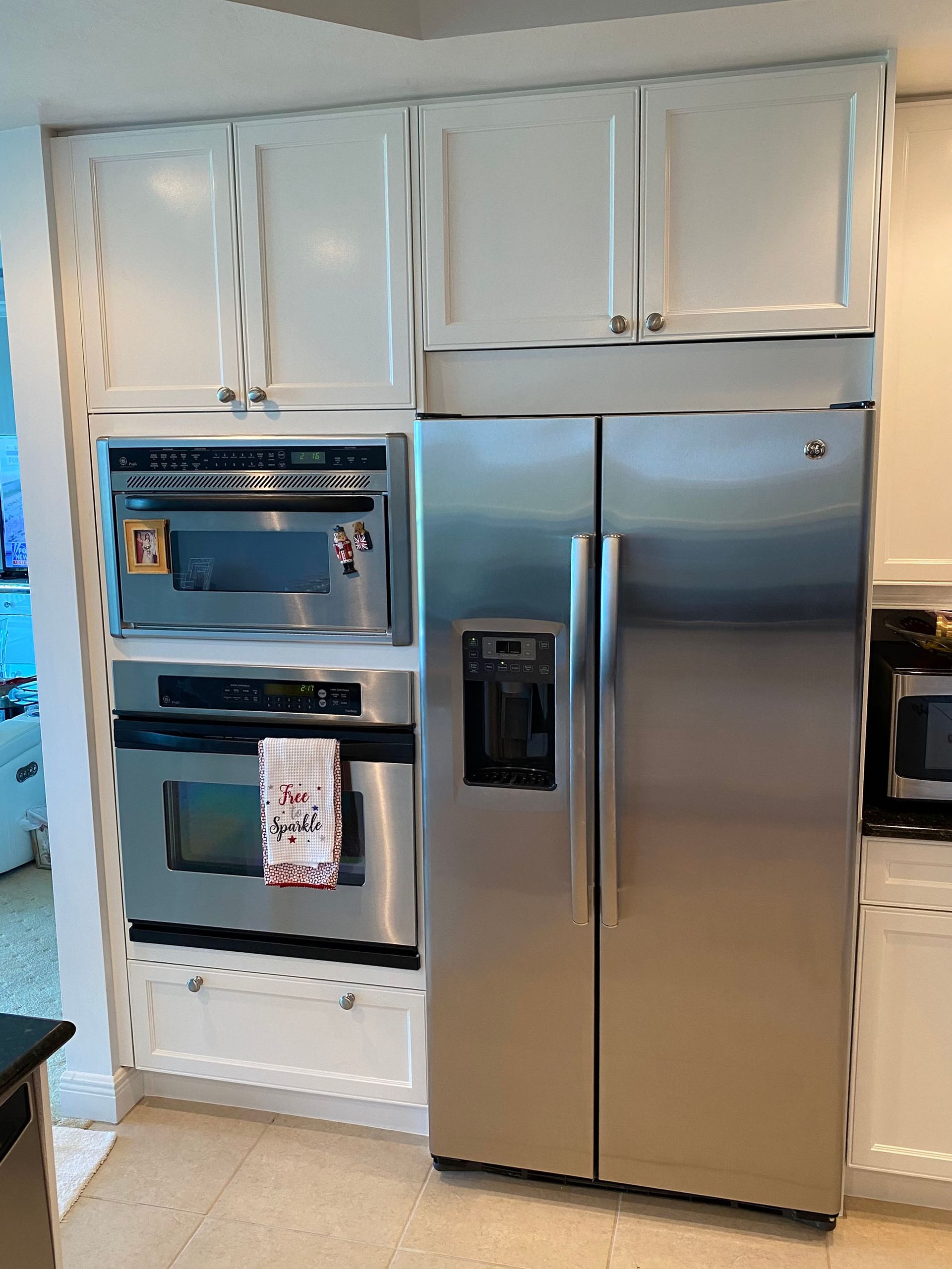 A kitchen with stainless steel appliances and a stainless steel refrigerator