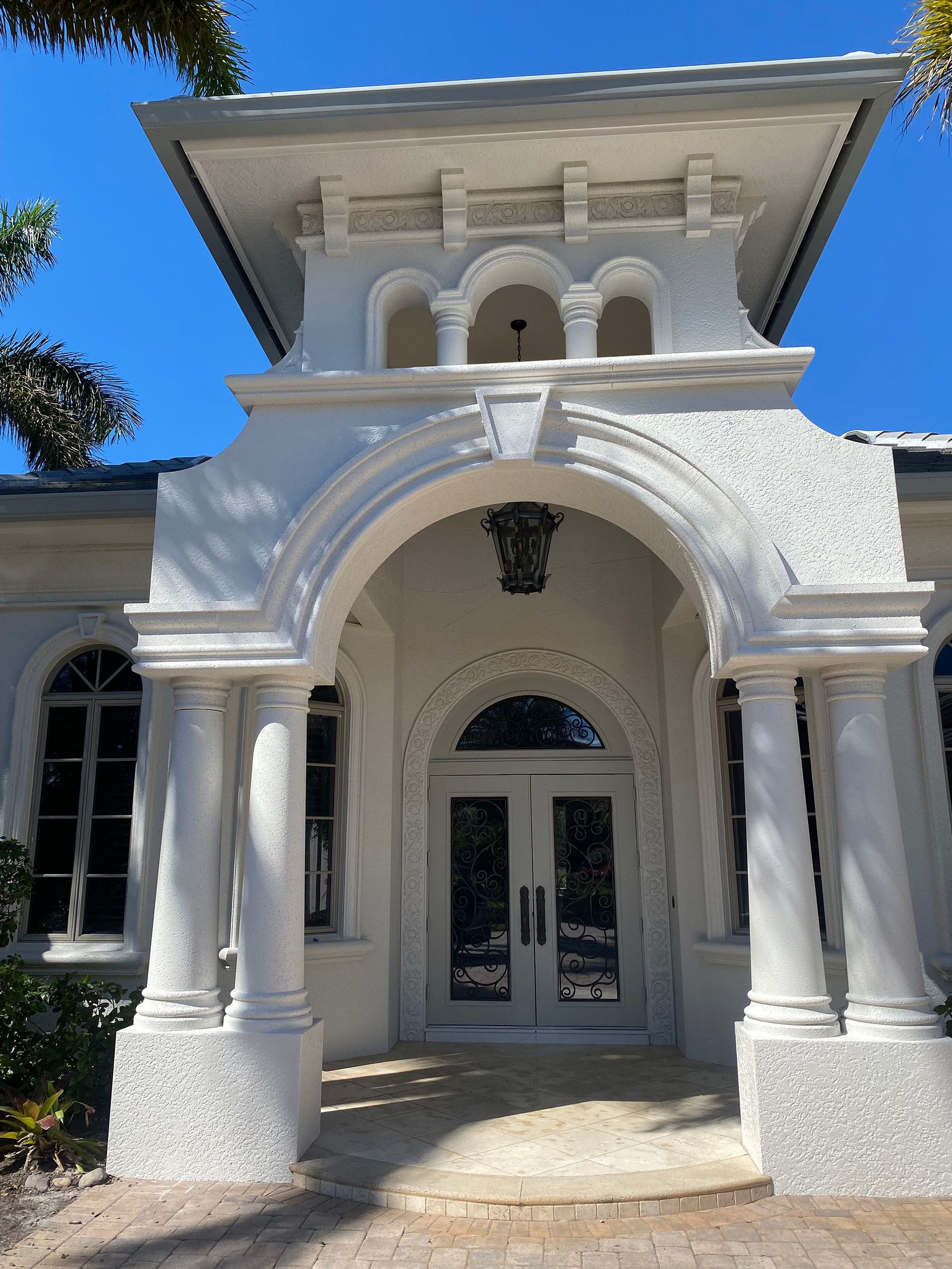 A white building with a tower on top of it.