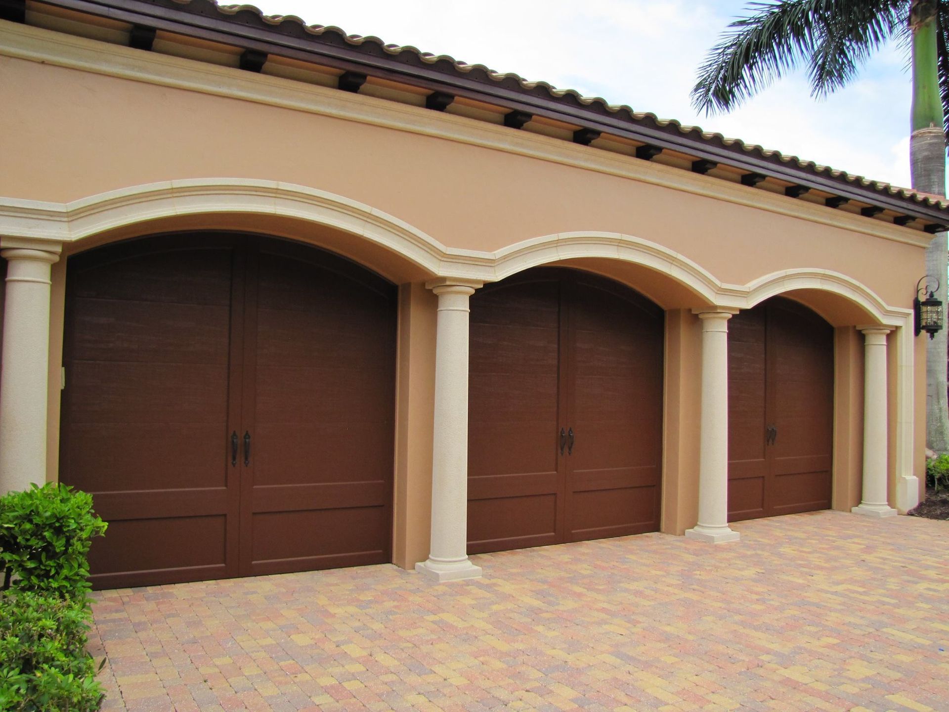 A row of brown garage doors on a building