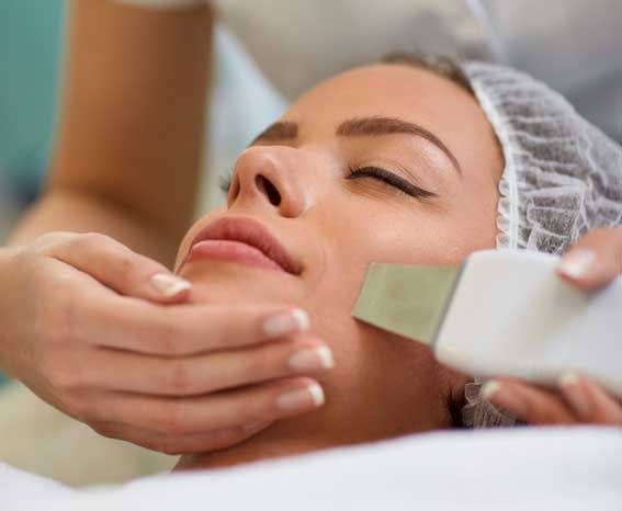 A woman is getting a facial treatment at a beauty salon.