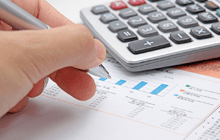 Businessman's hand showing diagram on financial report with pen