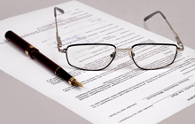 Agreement form, pen, and eyeglasses