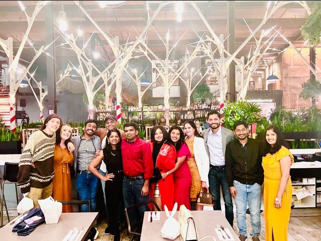 A group of people are posing for a picture in a restaurant.
