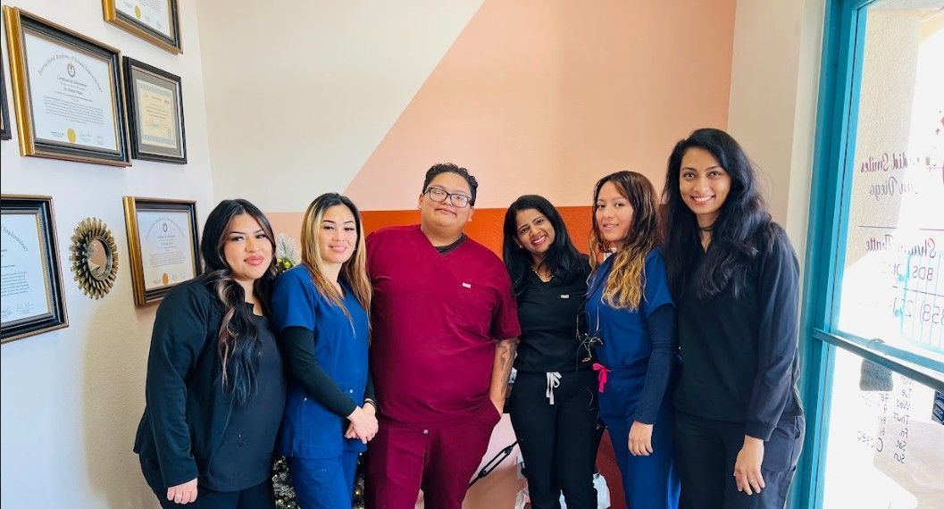 A group of people standing next to each other in a room.