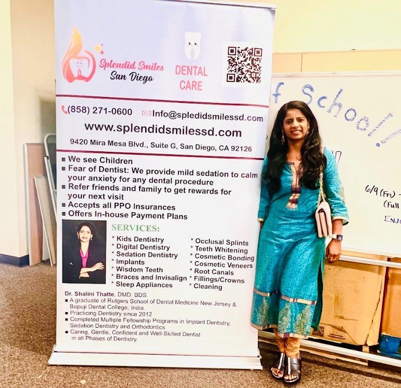 A woman is standing in front of a sign for dental care