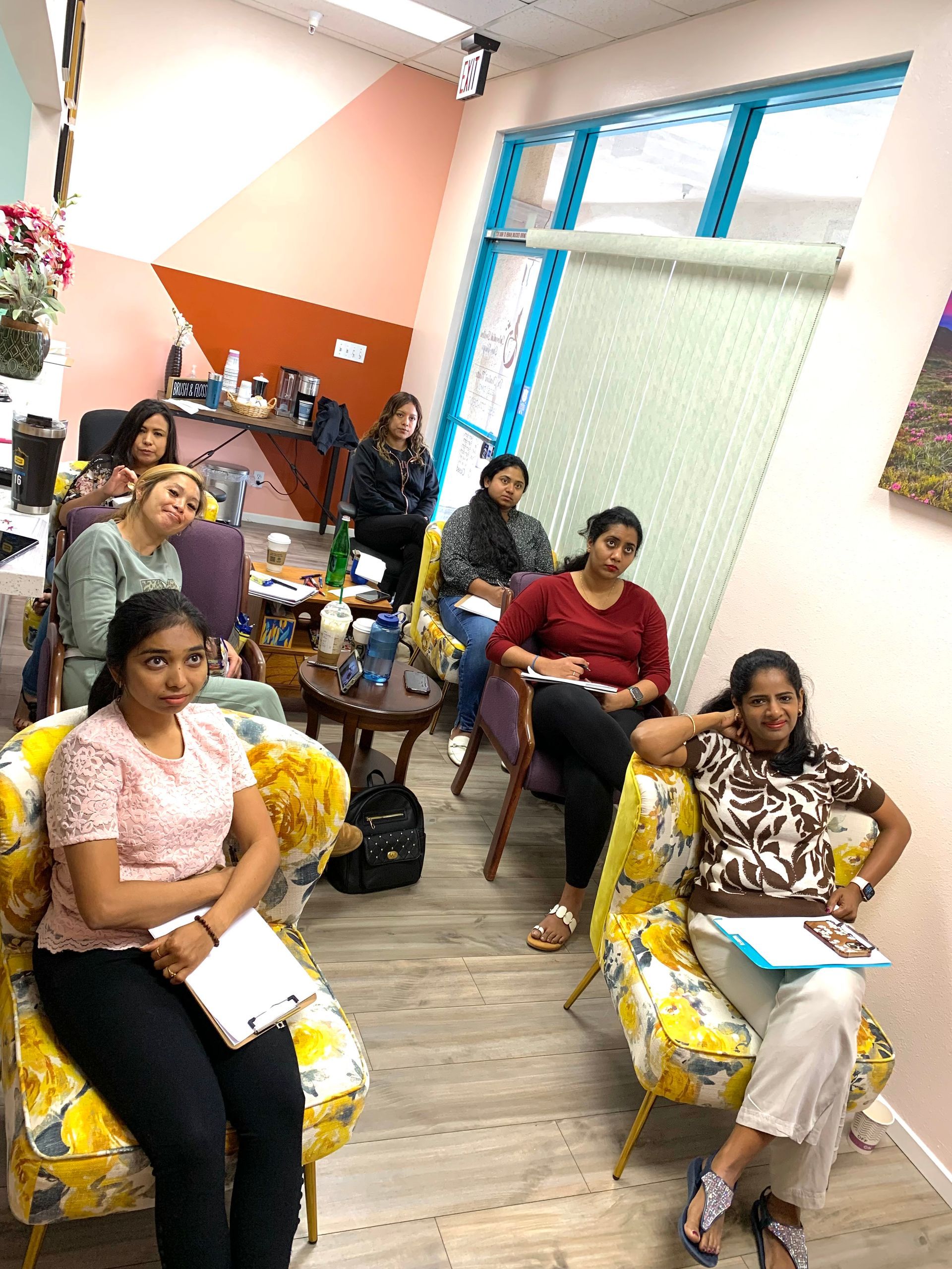 A group of women are sitting in chairs in a room.