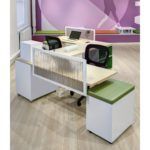 Modern office workstations with white and green accents.