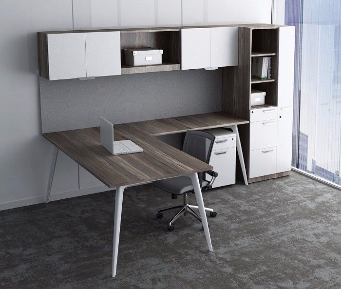 Modern L-shaped office desk with built-in storage, white accents, and a laptop.