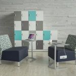 Office area with gray and teal lockers, chairs, and an ottoman.