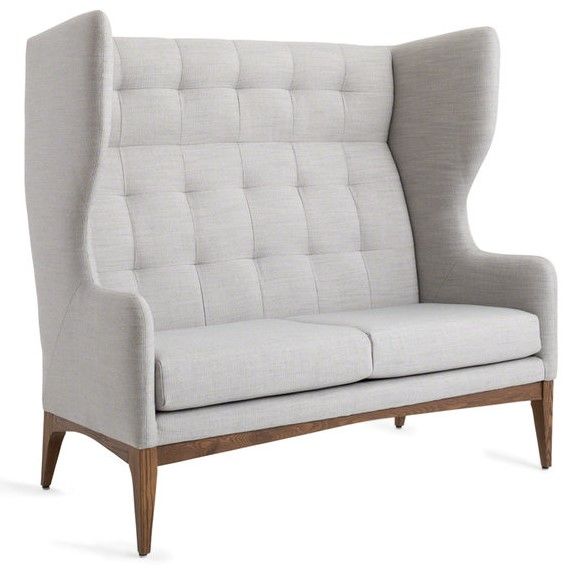 Light gray upholstered loveseat with tall, button-tufted back and wooden legs.