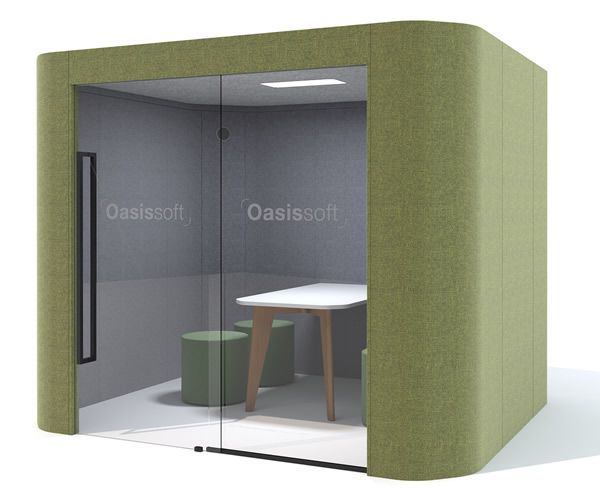 Green soundproof office pod with glass doors, white table, and stools.