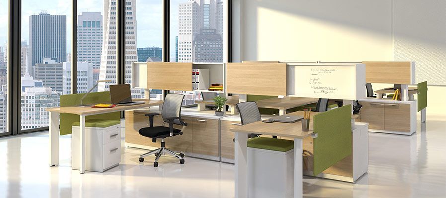 An open-plan office with multiple workstations. Large windows with a cityscape view. Neutral colors, desks, chairs, and filing cabinets.