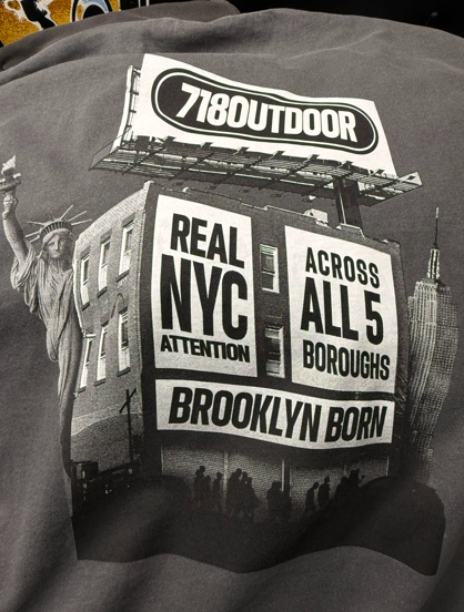 Gray graphic tee with billboard; Statue of Liberty, building, and Empire State Building; 