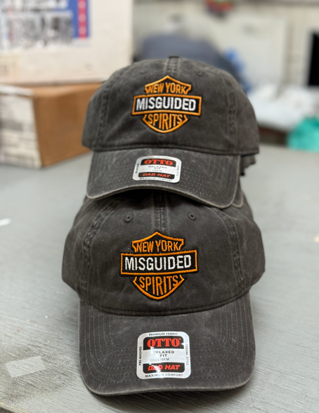 Three dark gray ball caps stacked, each with a 