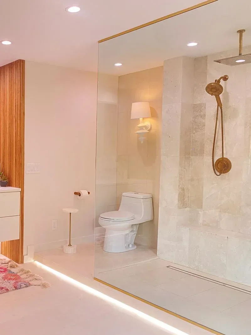 Bathroom with white tiles and gold fixtures