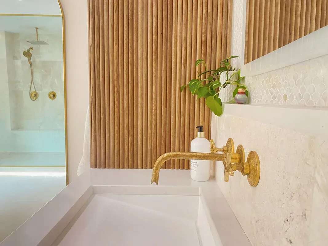 A modern bathroom with golden f