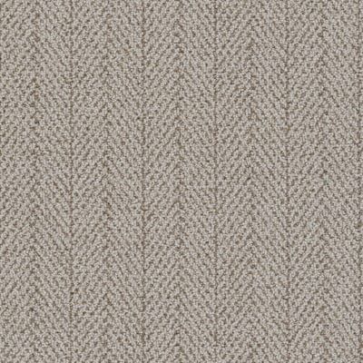 Close-up of beige carpet with a vertical herringbone pattern.