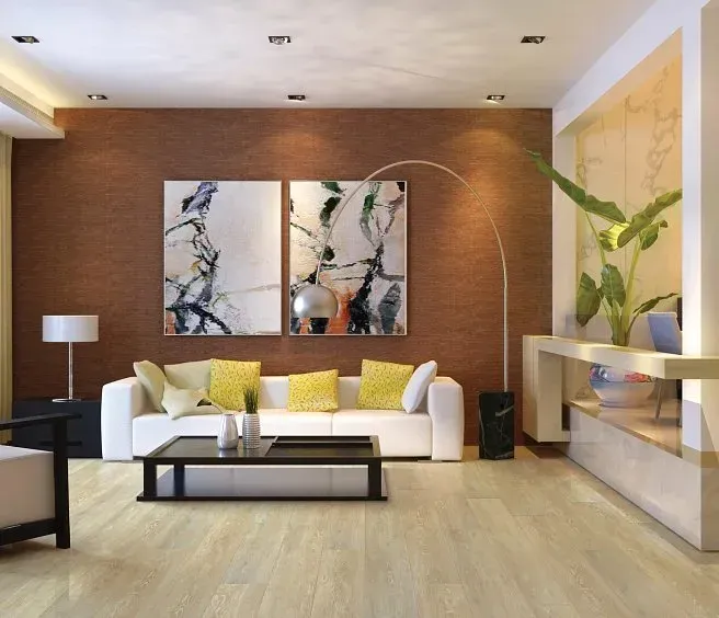 Modern living room with white sofa, art, and plant against a brown textured wall.
