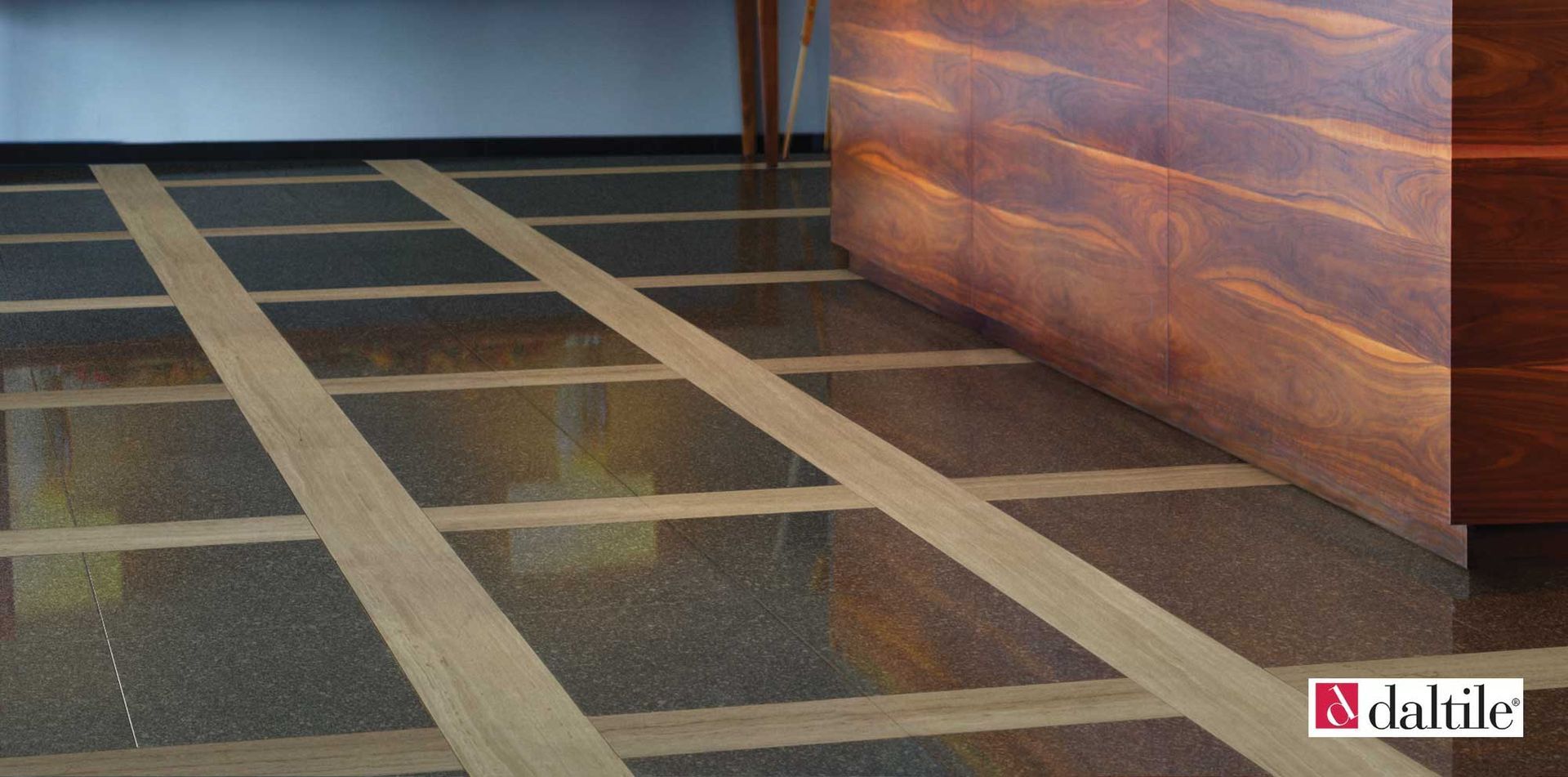 Floor with brown and gray tiles separated by light wooden strips, next to a wooden wall.