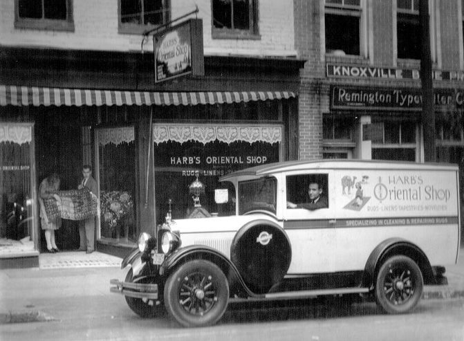 Vintage photograph of a white delivery truck parked outside