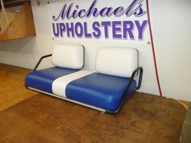 Blue and white bench seat with two white cushions in a Michaels Upholstery showroom