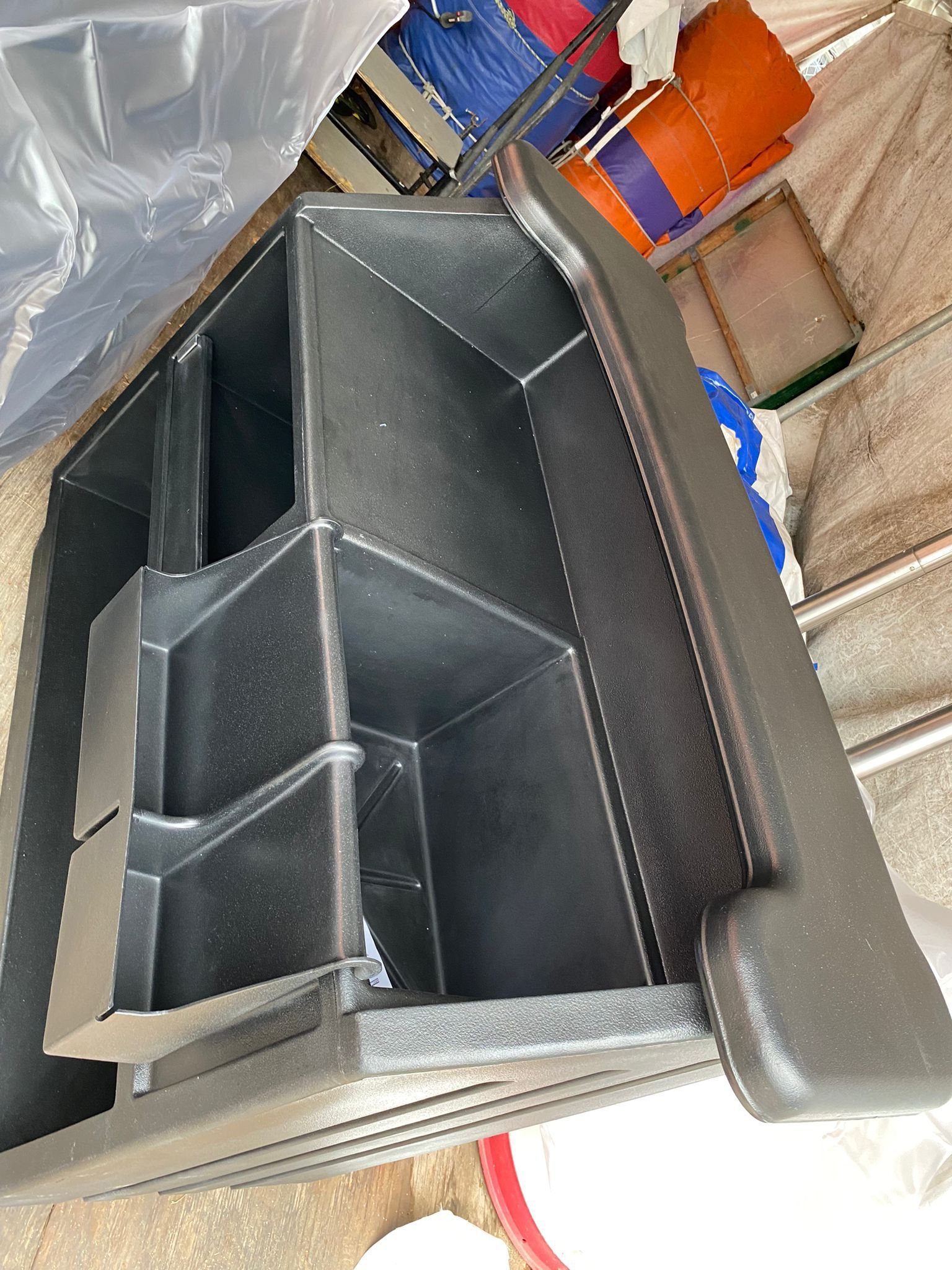 Black plastic organizer with compartments, likely for a vehicle console or storage.
