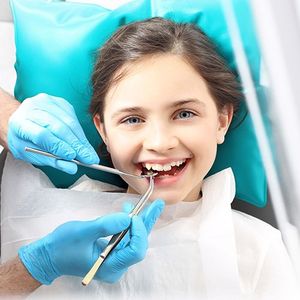 Girl smiling under dental procedure