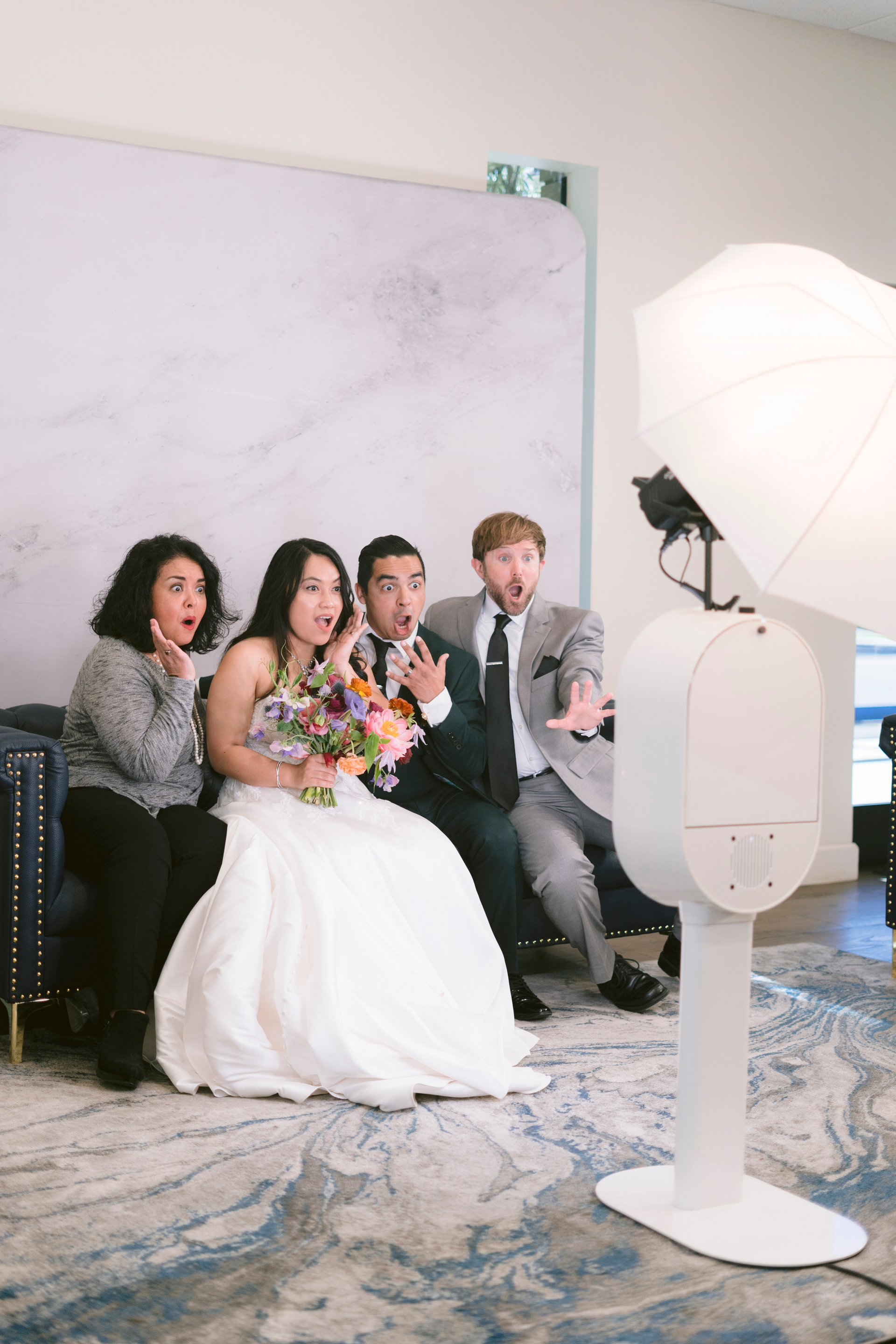 A group of people are posing for a picture in front of a photo booth.