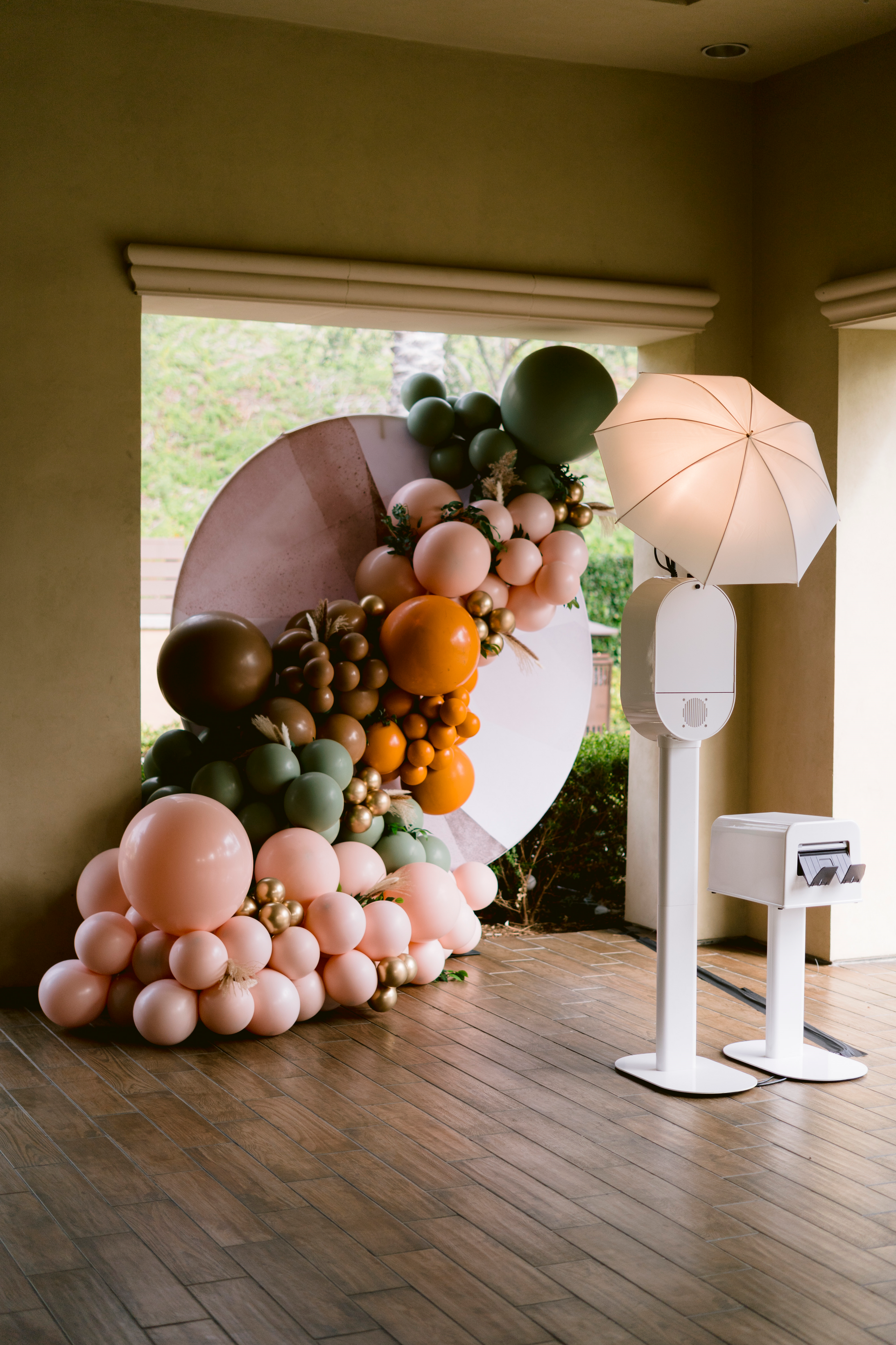 A room filled with balloons and a photo booth.